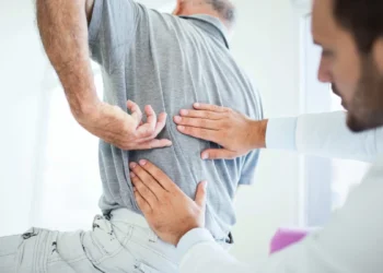 When does lower back pain require a rheumatologist